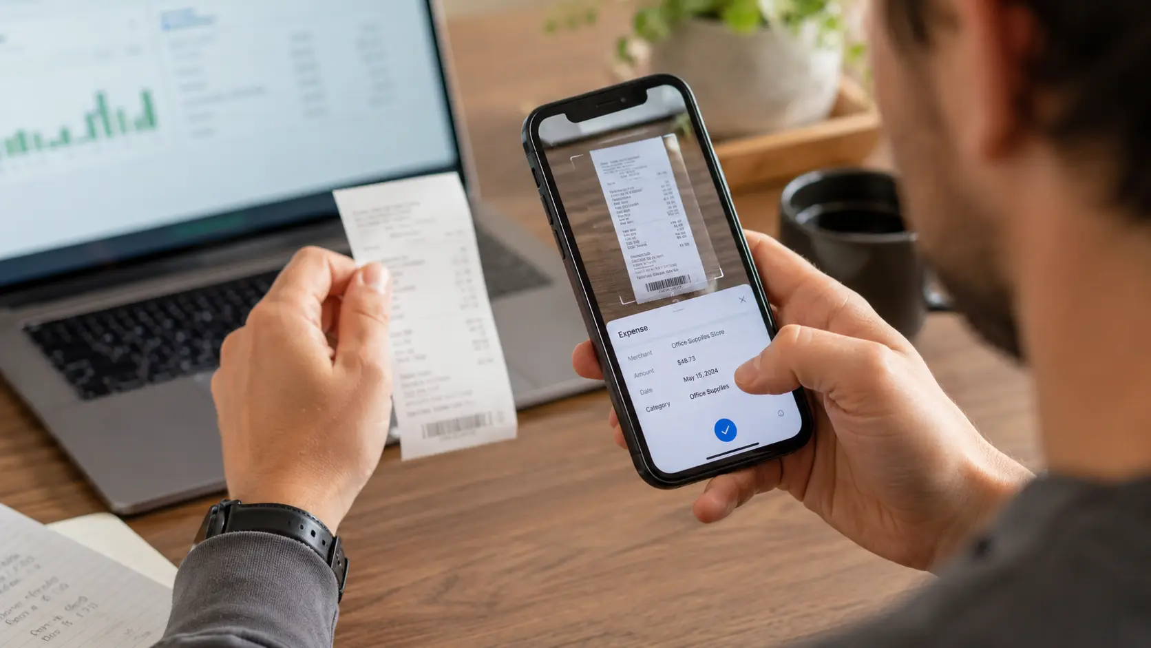 Self-employed professional capturing receipt with phone for expense tracking Self-employed professional capturing receipt with phone for expense tracking