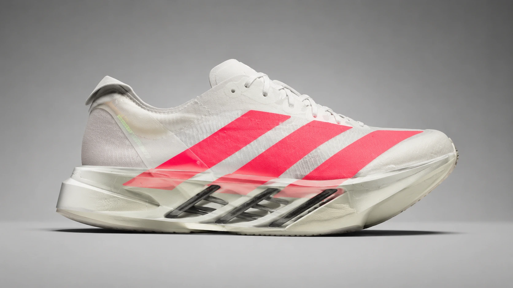 Side profile of Adidas Adios Pro 4 with visible carbon energy rods and Lightstrike Pro midsole