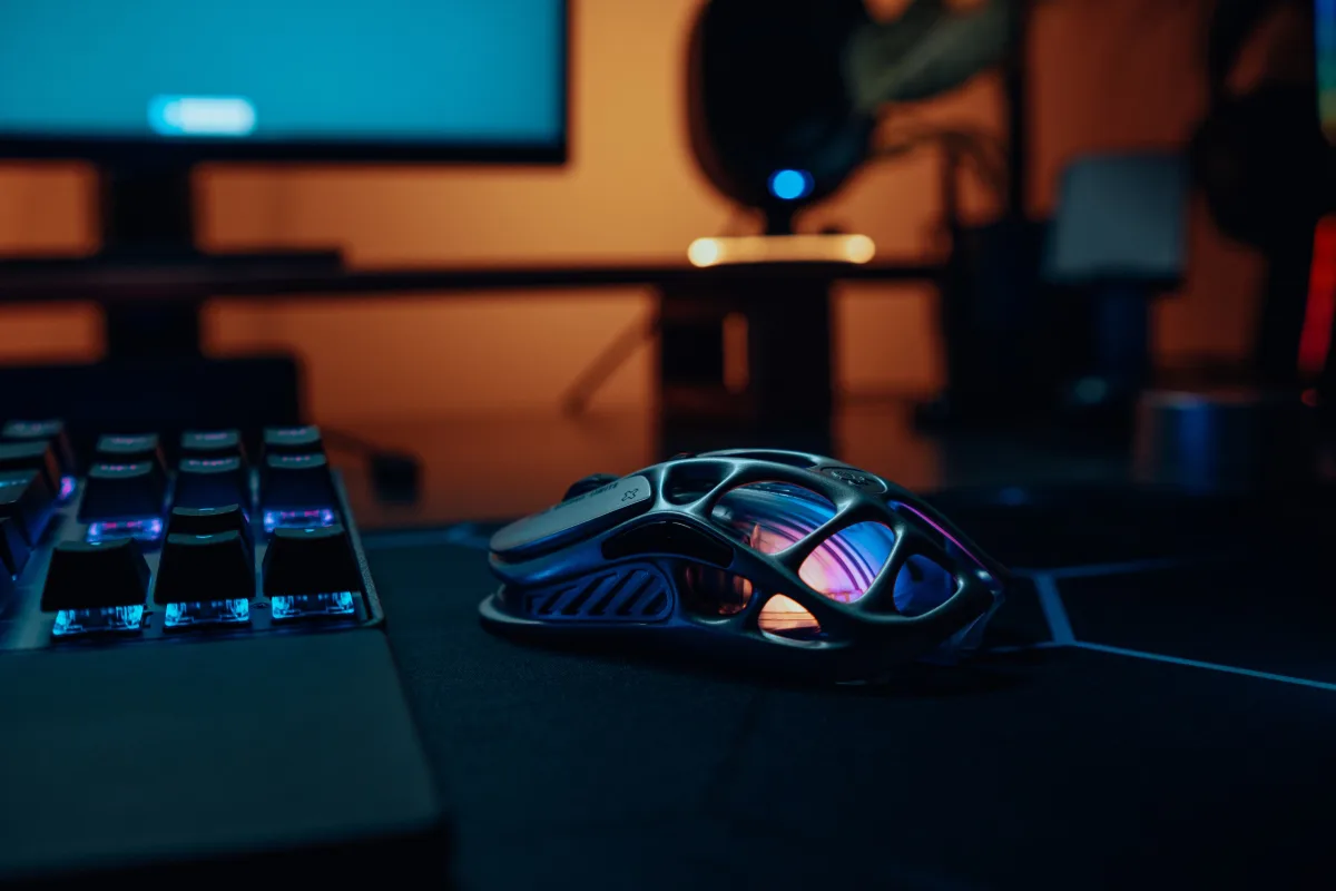 Gaming keyboard and mouse on a neon-lit desk