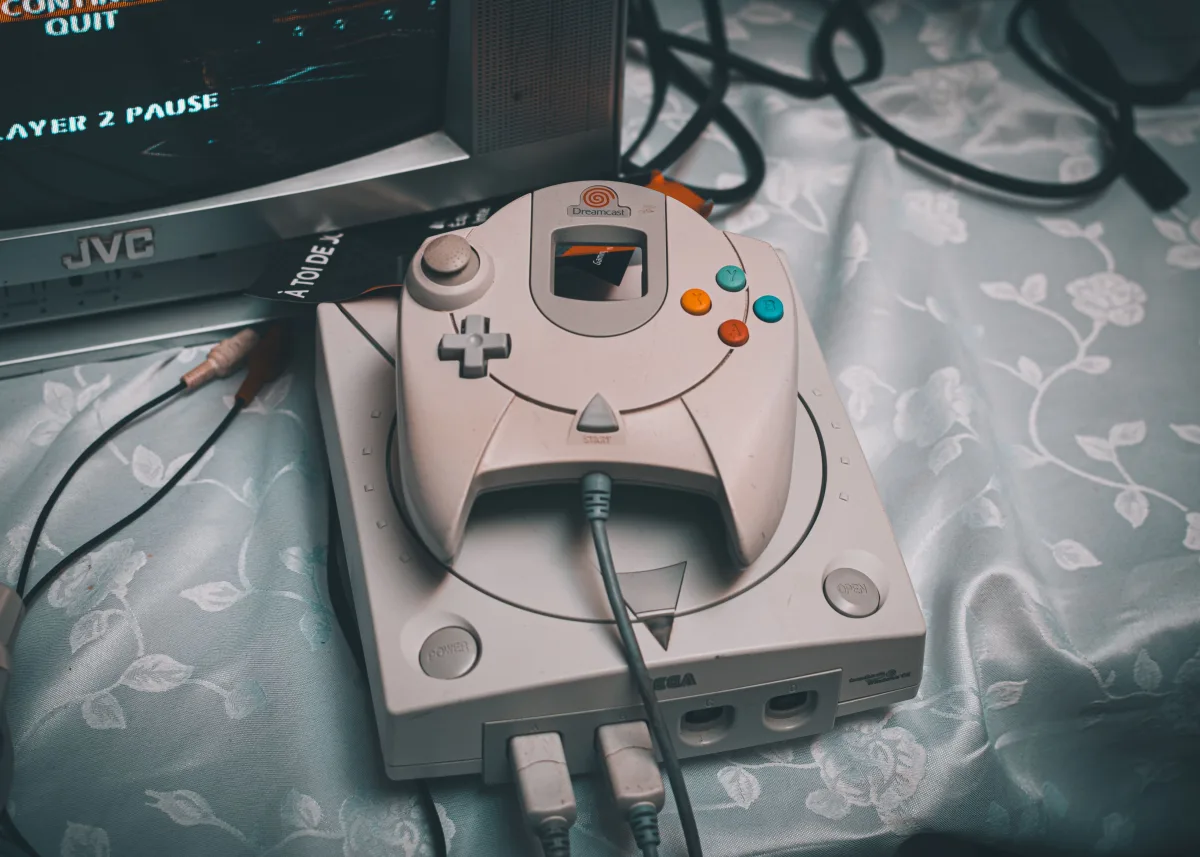 Sega Dreamcast console with controller and CRT monitor in a retro gaming setup