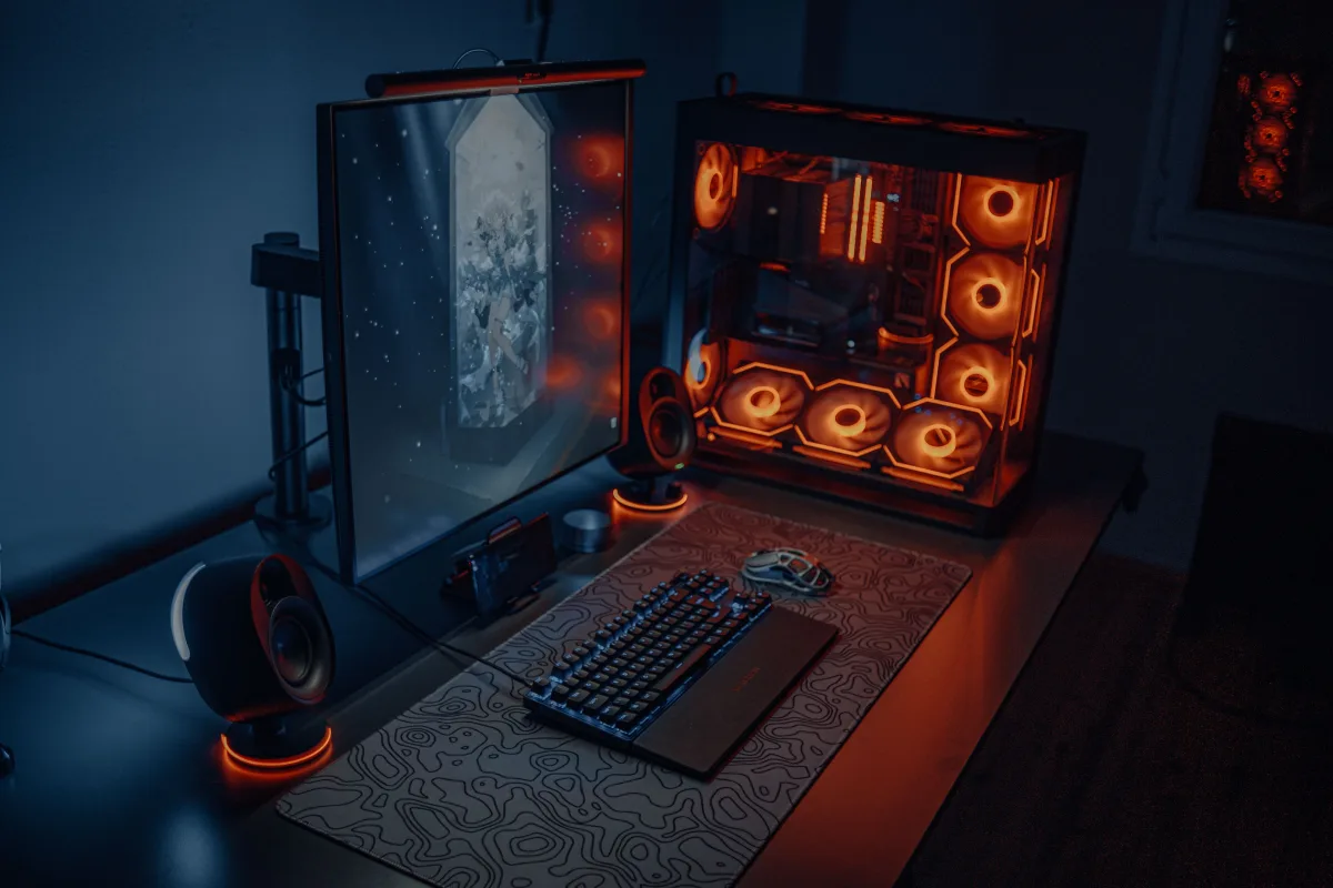 Modern gaming desk setup with RGB lighting and monitor