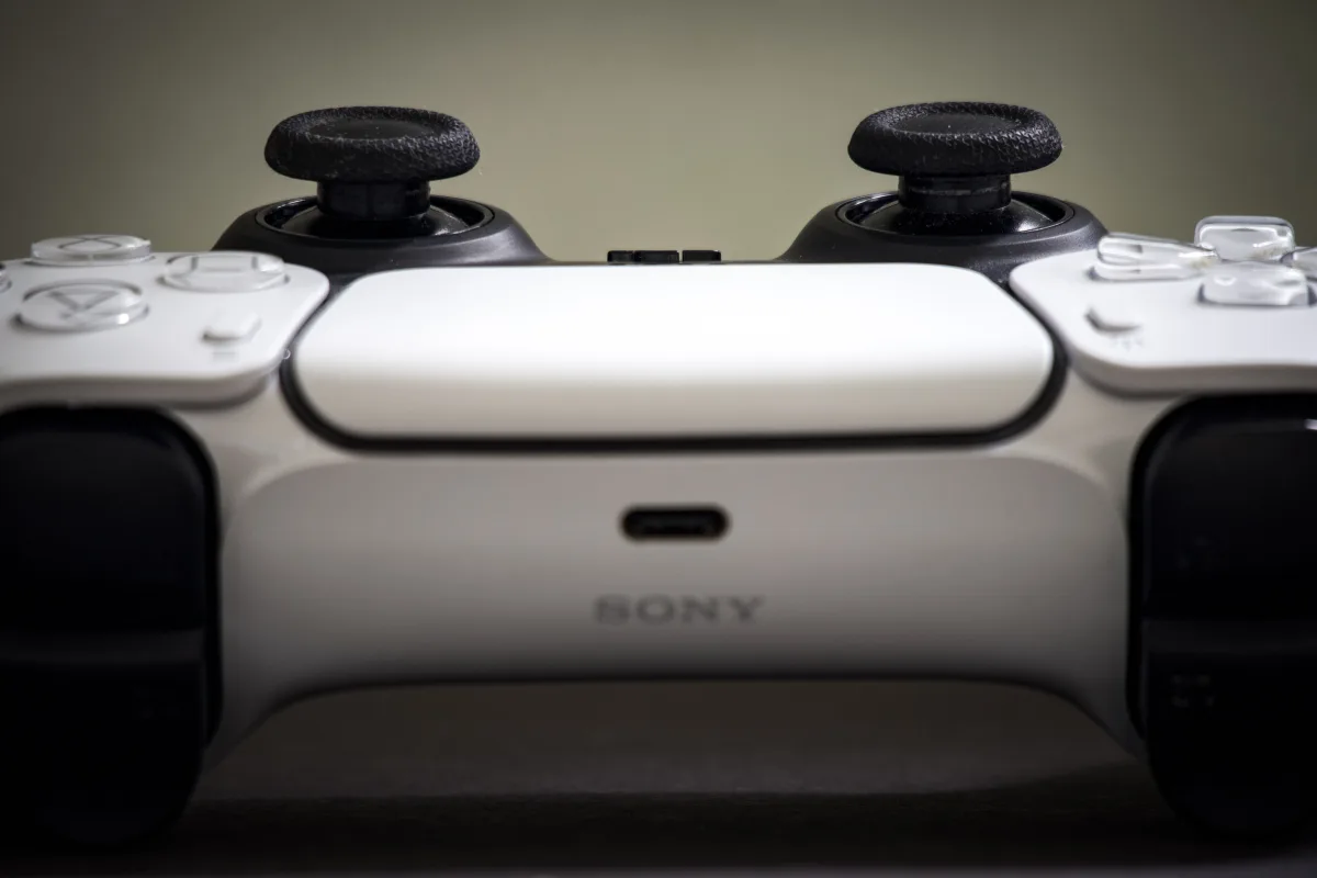 Close-up of a PS5 DualSense controller — PSN codes are region-locked and require careful verification