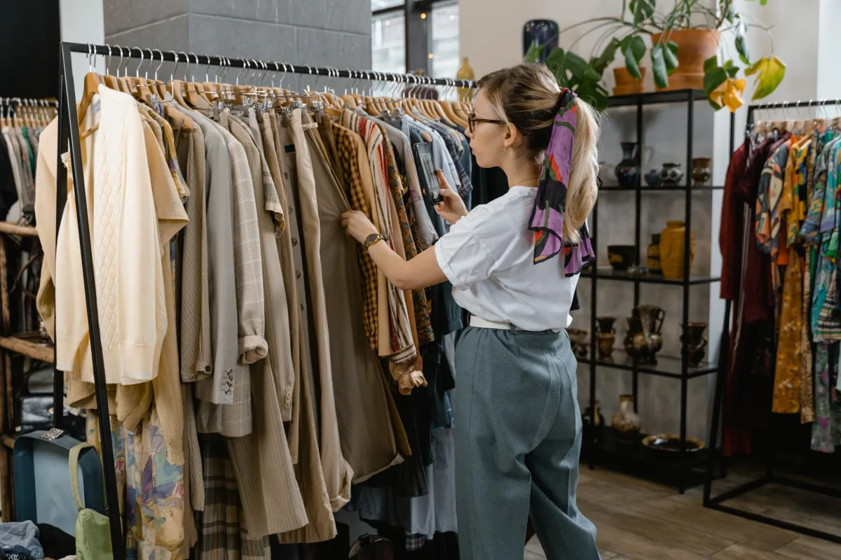 Person holding shopping bags outside a luxury retail store