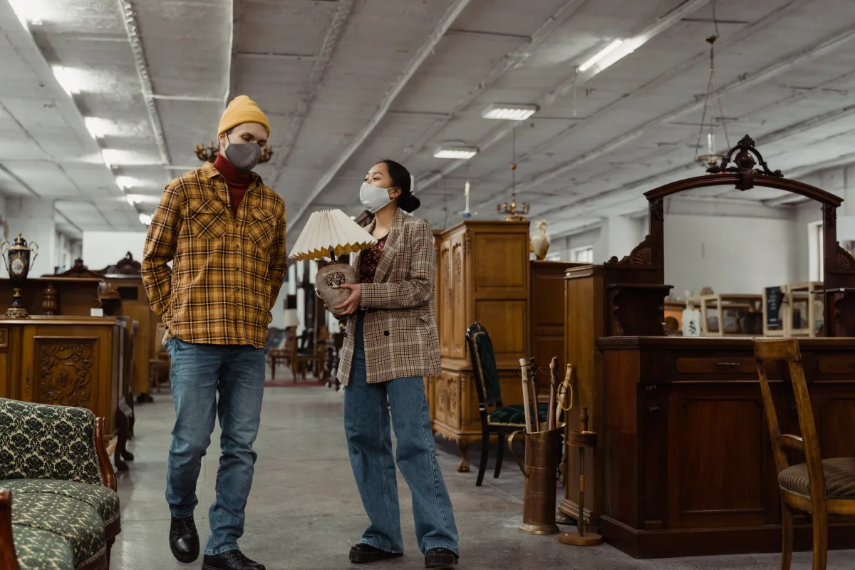 Shoppers browsing furniture with a sales associate