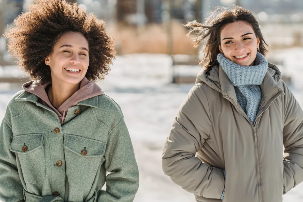 Women in winter coats walking on snowy city street