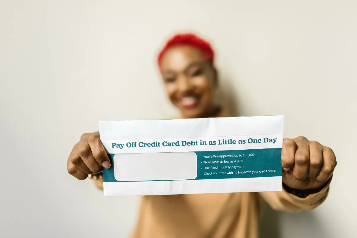 Person reviewing personal loan documents with credit card on desk