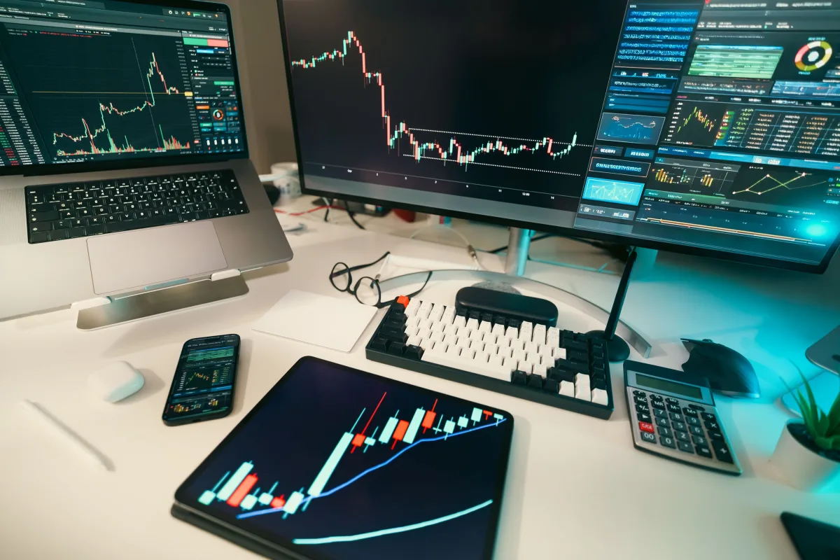 Modern trading desk with screens displaying financial charts and AI analysis