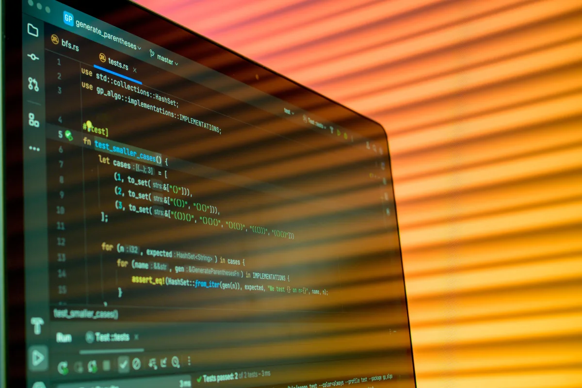 Close-up of computer screen displaying code with orange lighting