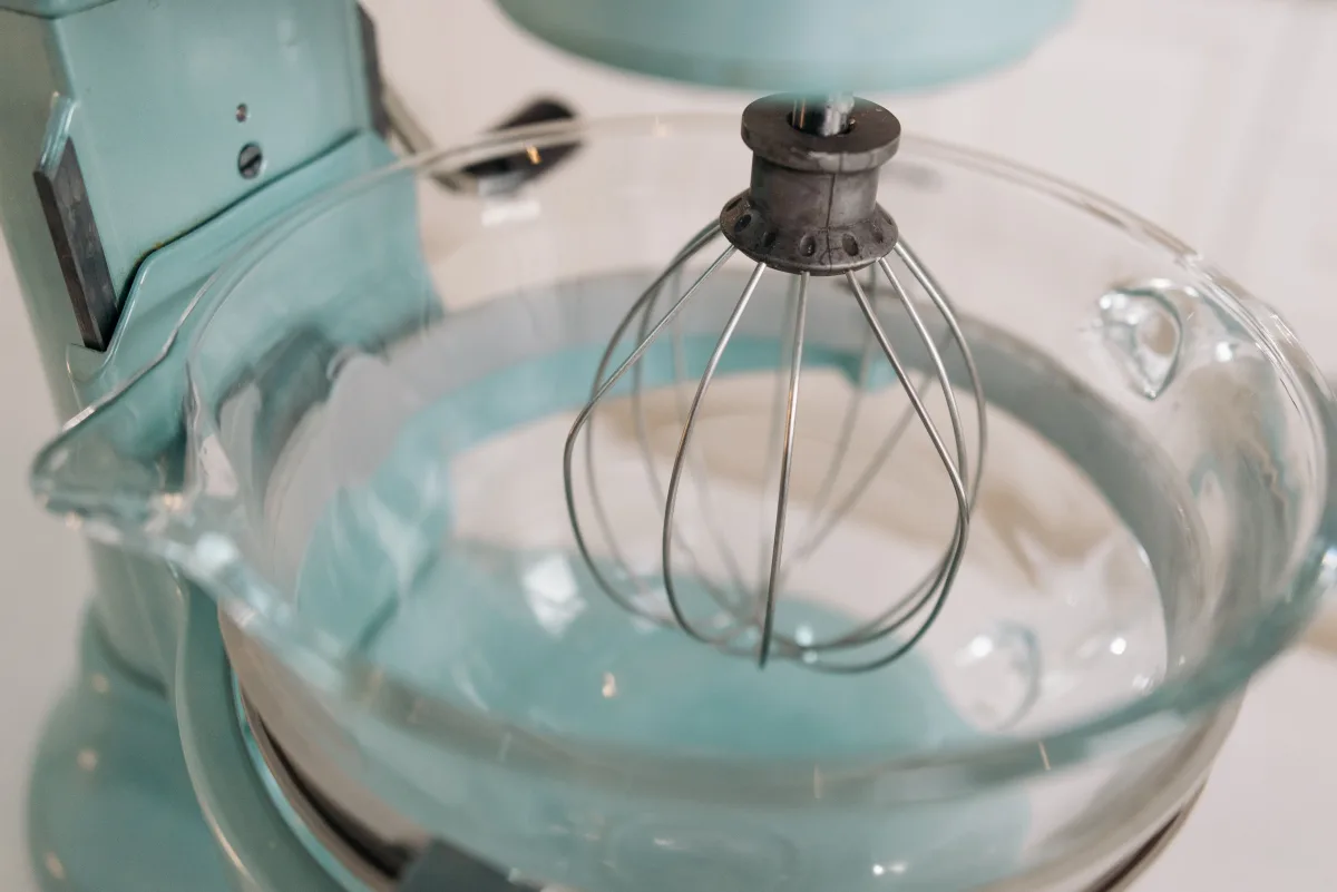 Stand mixer with whisk attachment and glass bowl