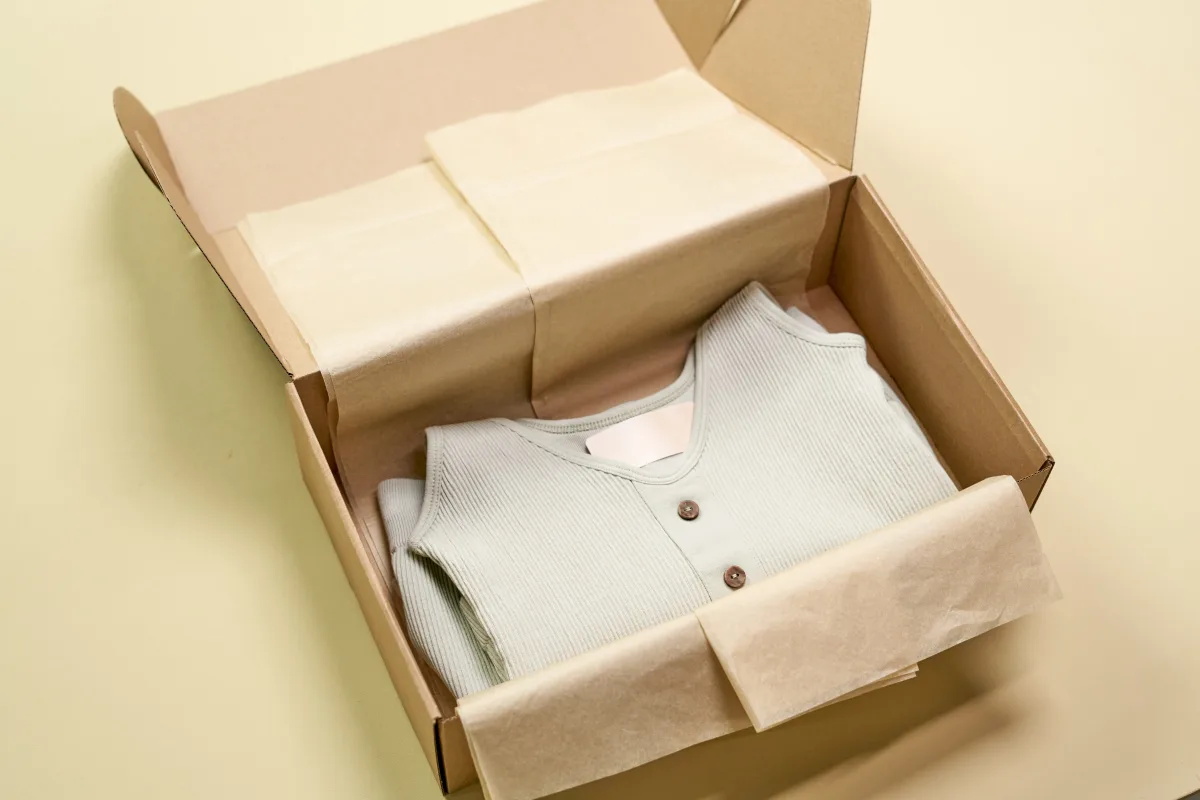 Neatly folded clothes packed in a cardboard box for a clothing subscription service