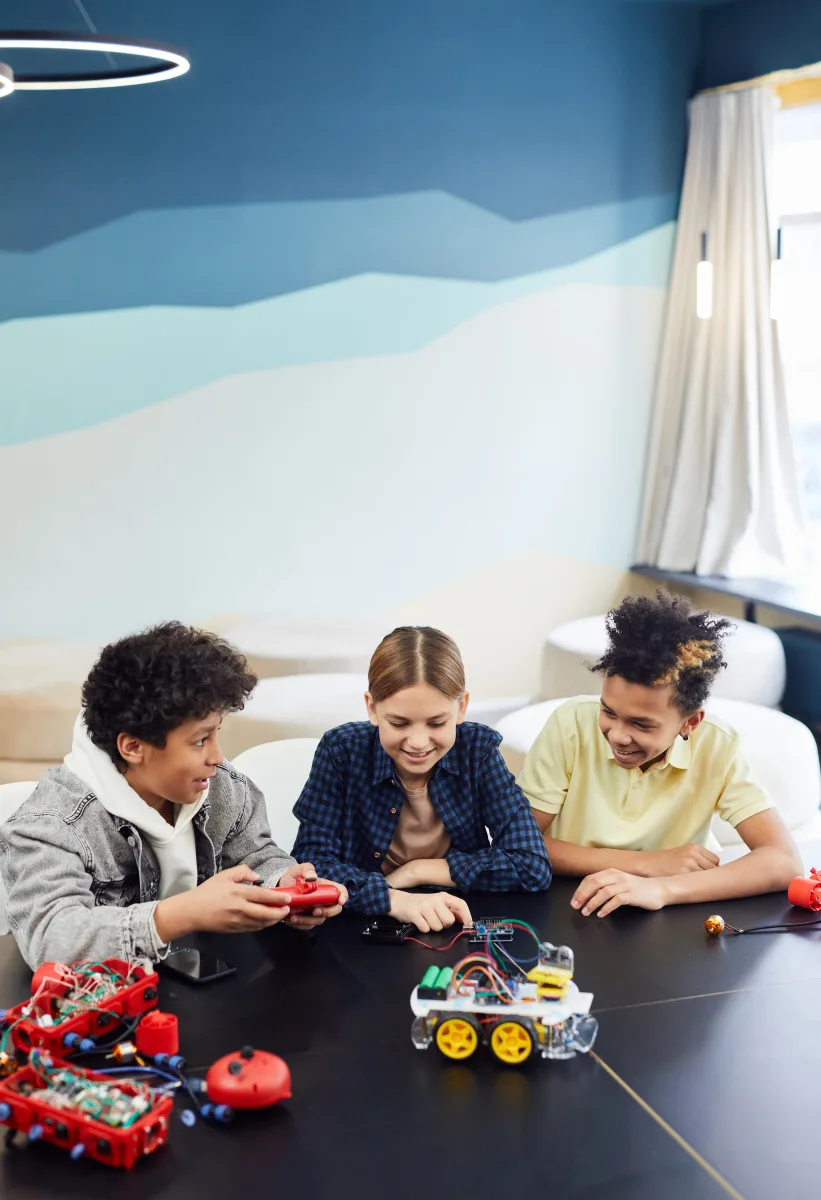 Three children building and playing with robotics toys — best STEM toys ages 6 to 8 years 2026