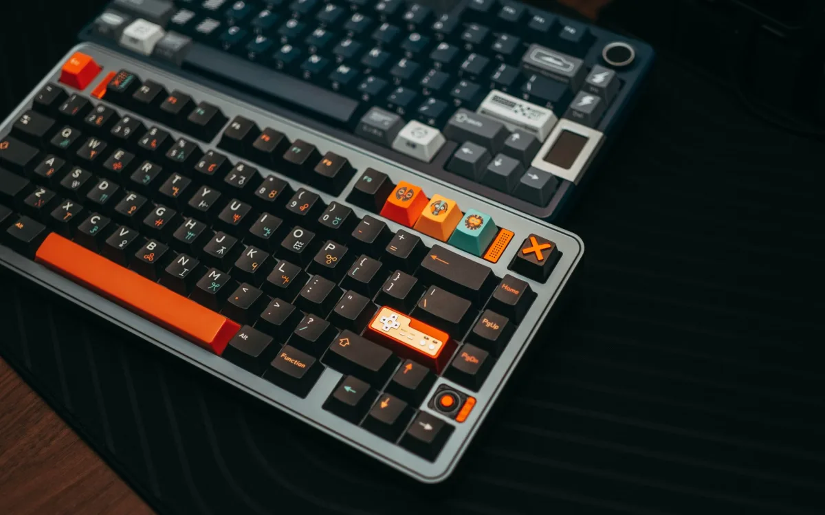 Colorful mechanical keyboards on a desk with unique keycaps