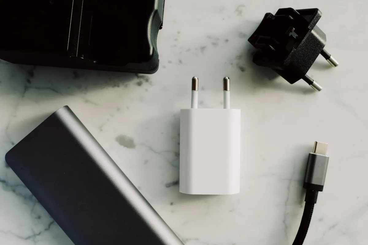 Collection of USB-C and multi-port charging adapters on a marble surface
