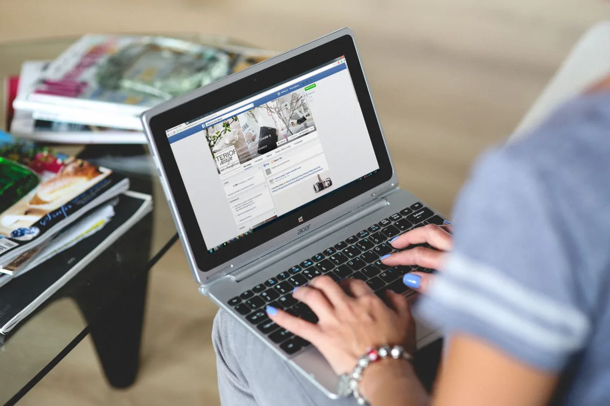 Marketing professional creating social media graphics on laptop