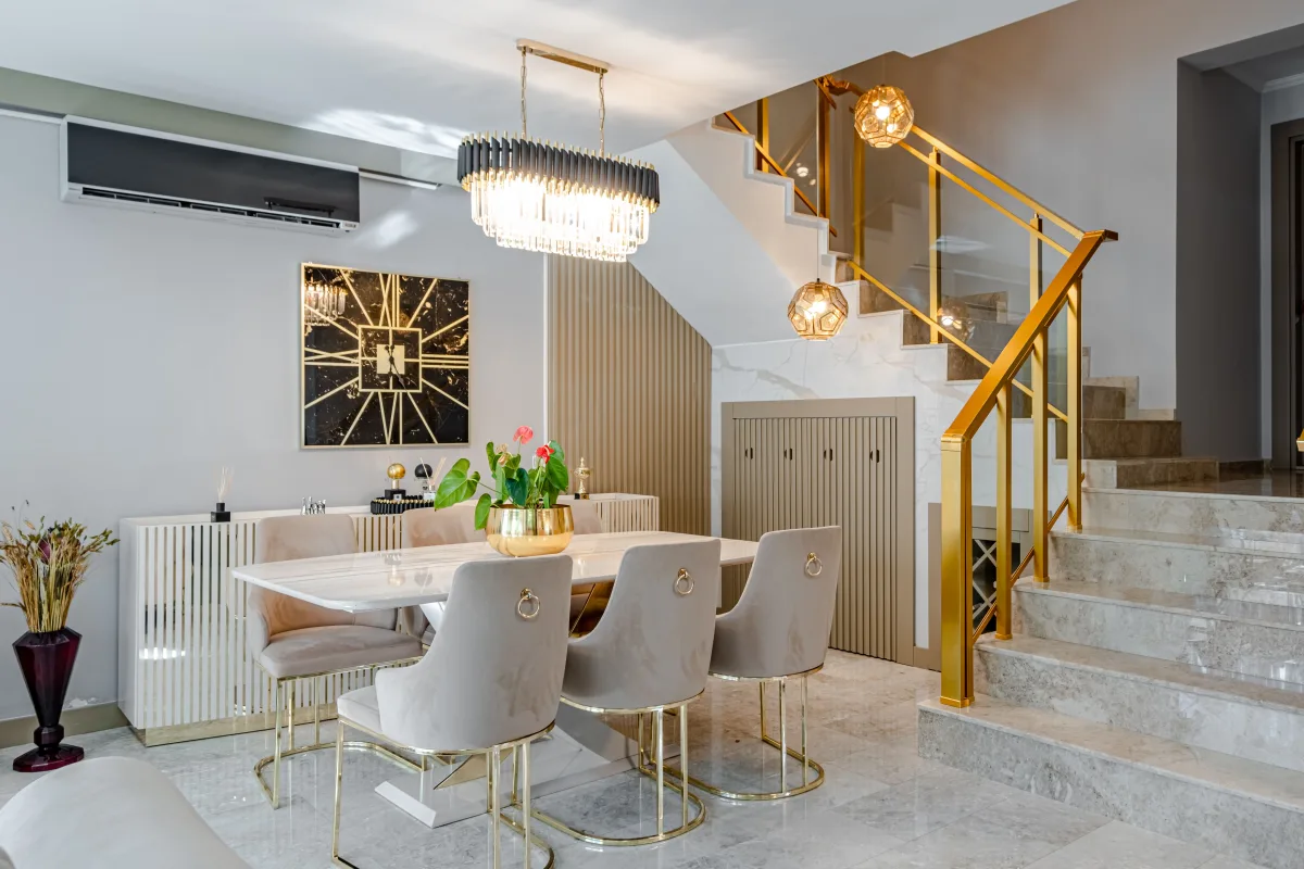 Luxury marble-top dining table with gold accents and pendant lighting