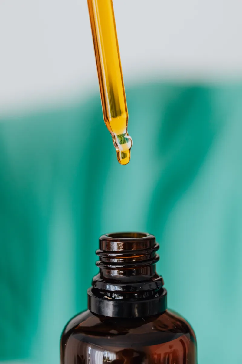 Dropper serum bottle for retinol skincare routine on white background