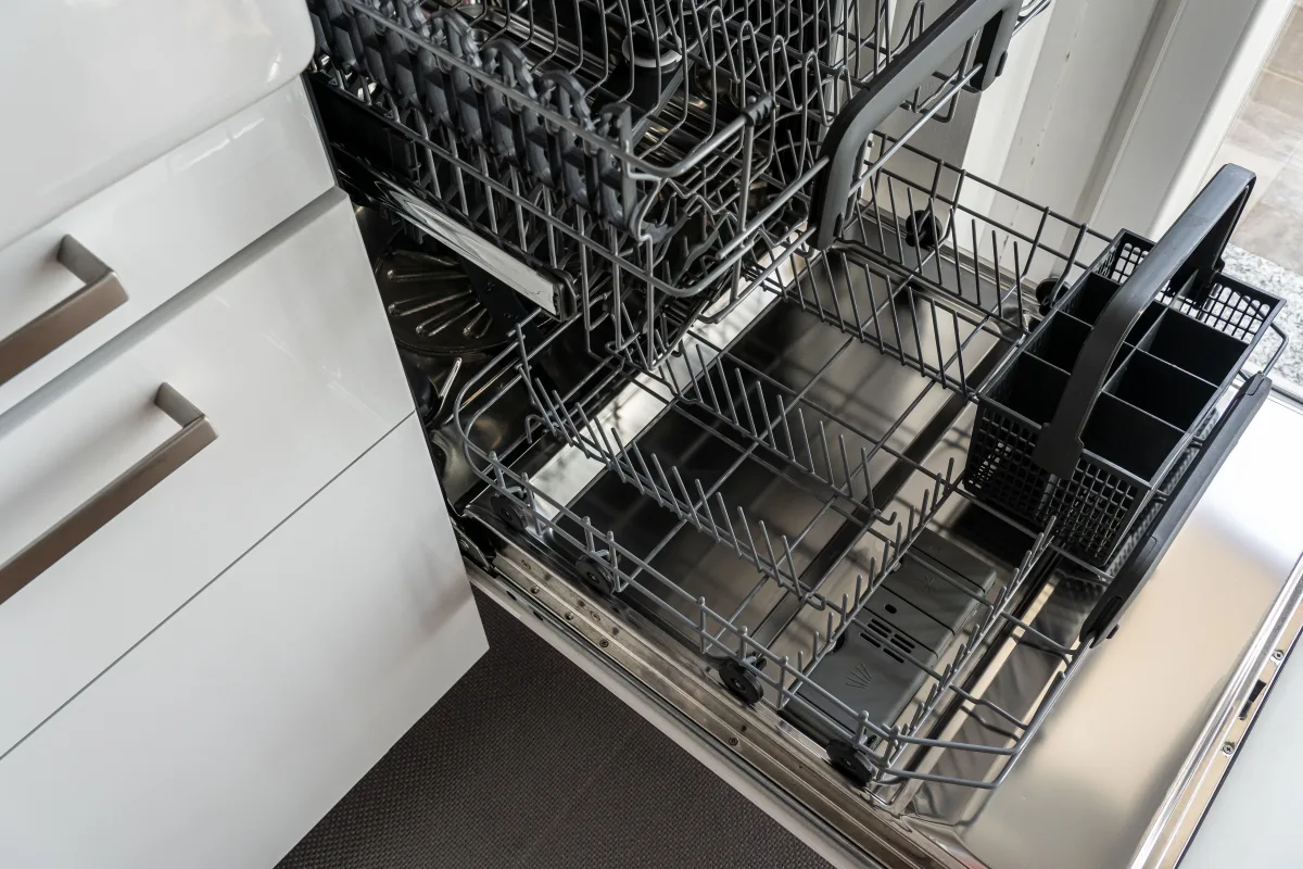 Open built-in dishwasher in a bright modern kitchen