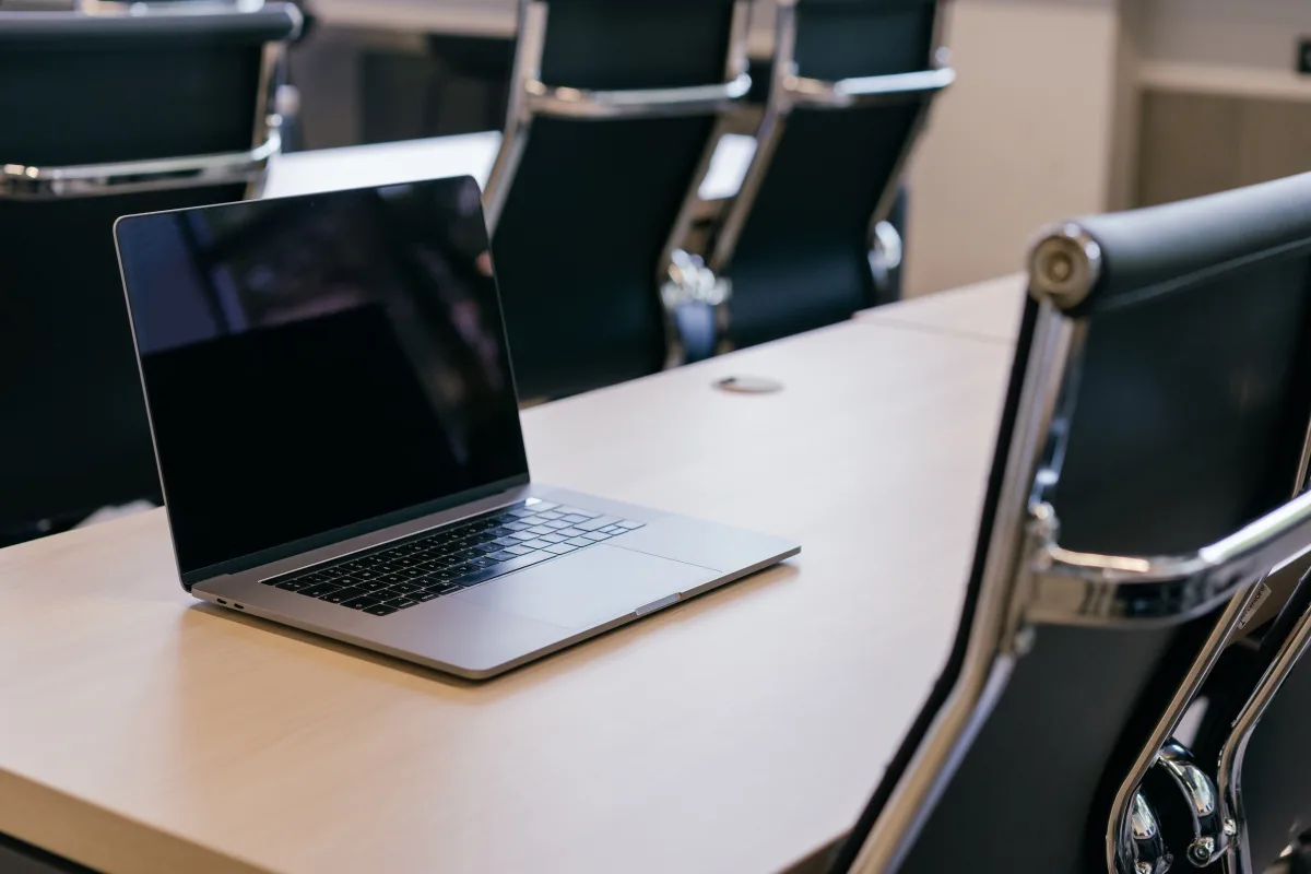 Conference table with ergonomic black chairs in a modern office, representing furniture buying criteria
