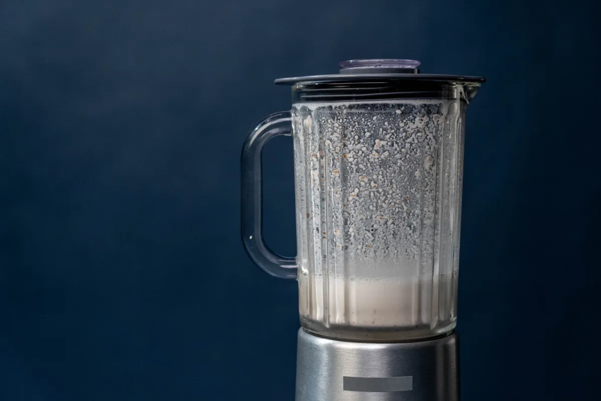 Close-up of a high-powered blender processing frozen fruit — heavy-duty daily blending