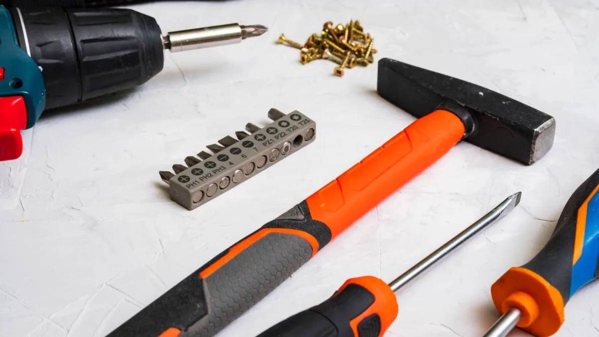 Selection of hand tools including a hammer, screwdriver, and drill bits for home projects