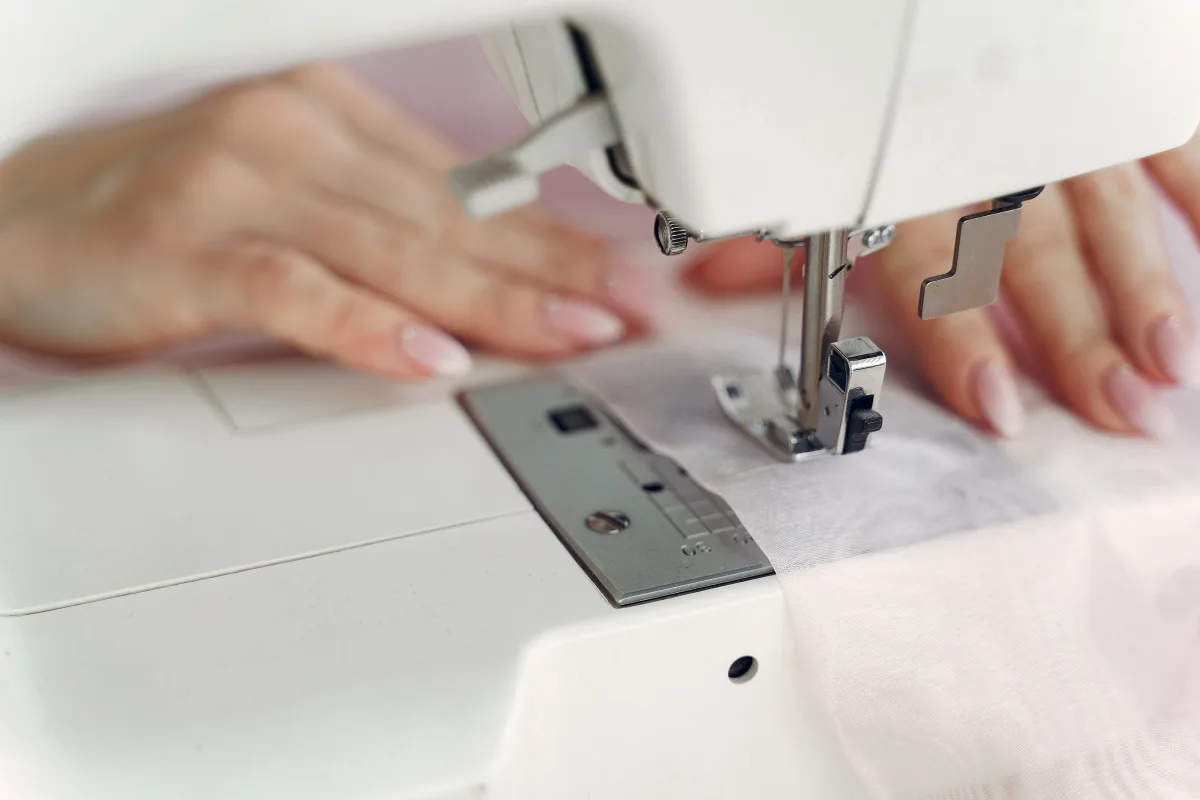 Seamstress operating a sewing machine in a workshop