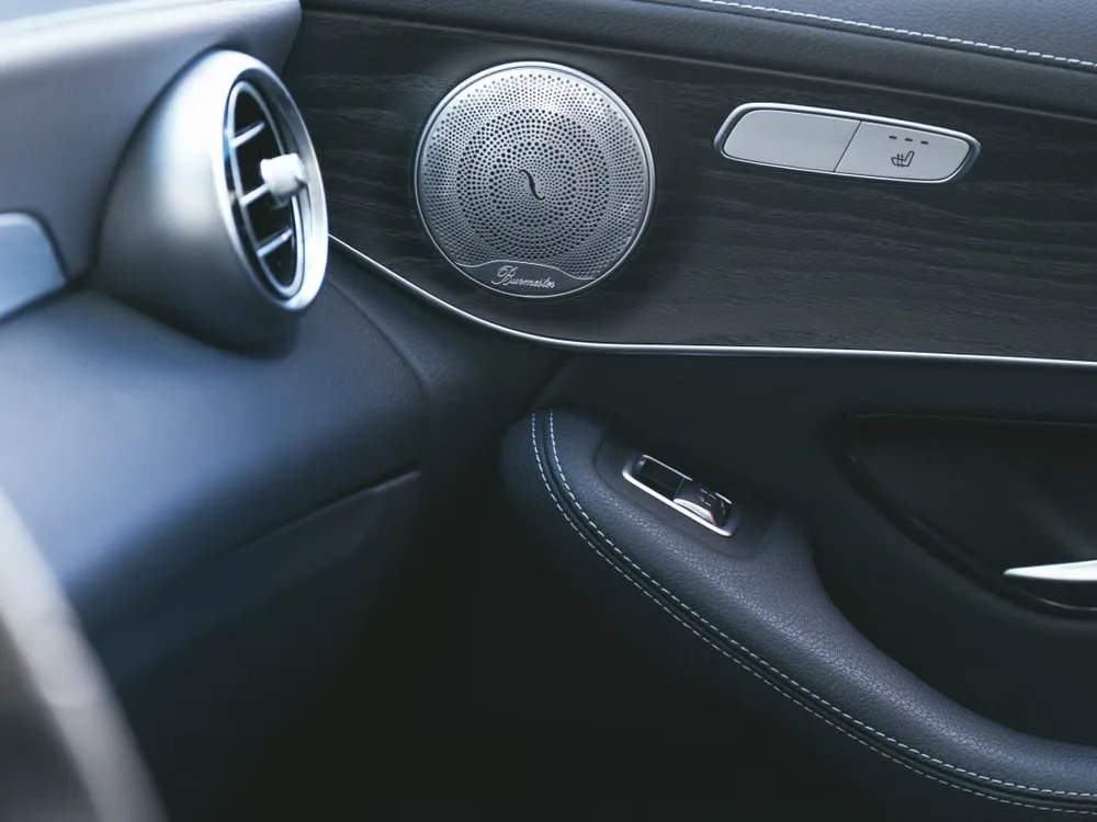 Luxury car interior close-up showing speaker grille design