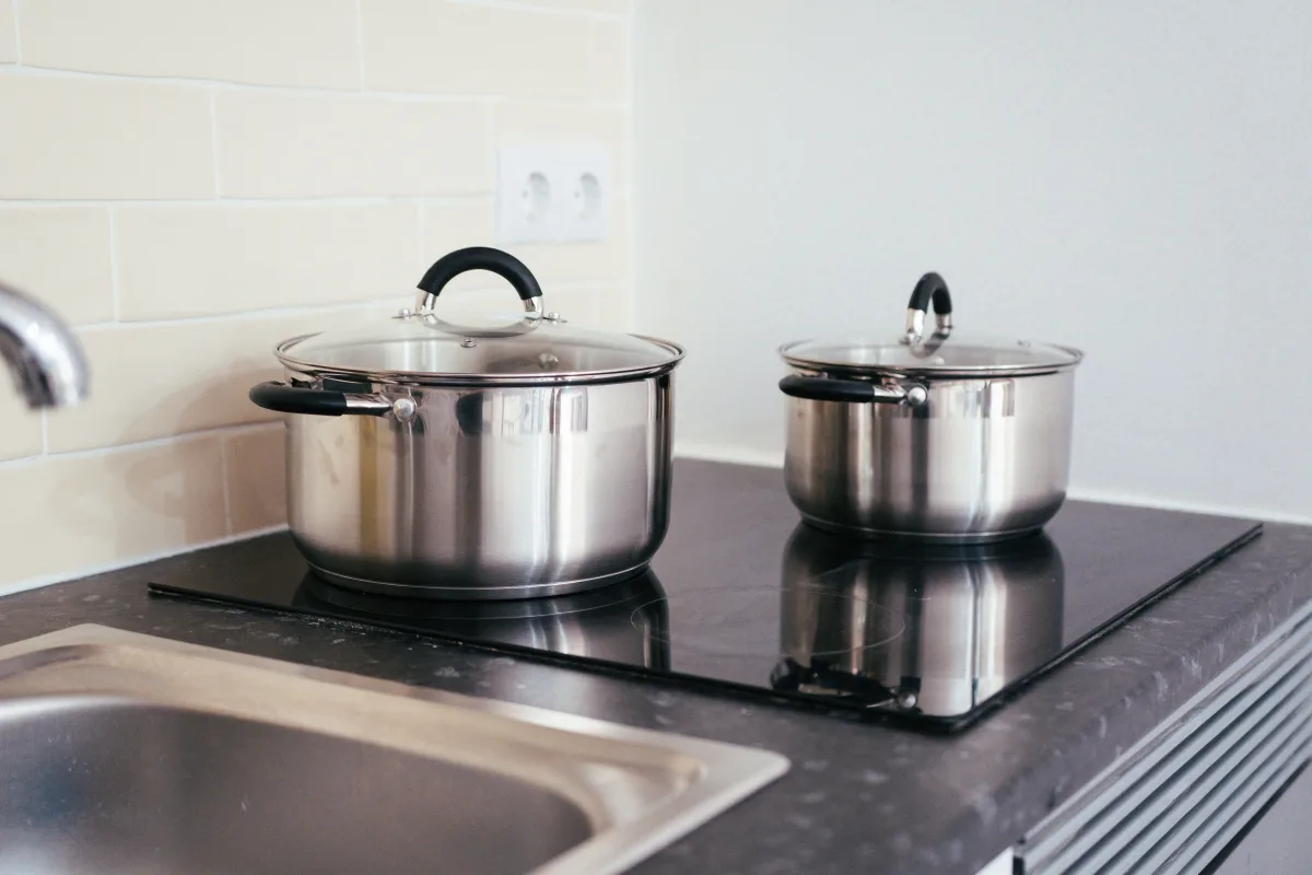 Induction cooktop with stainless steel pot showing fast boil — induction vs gas comparison