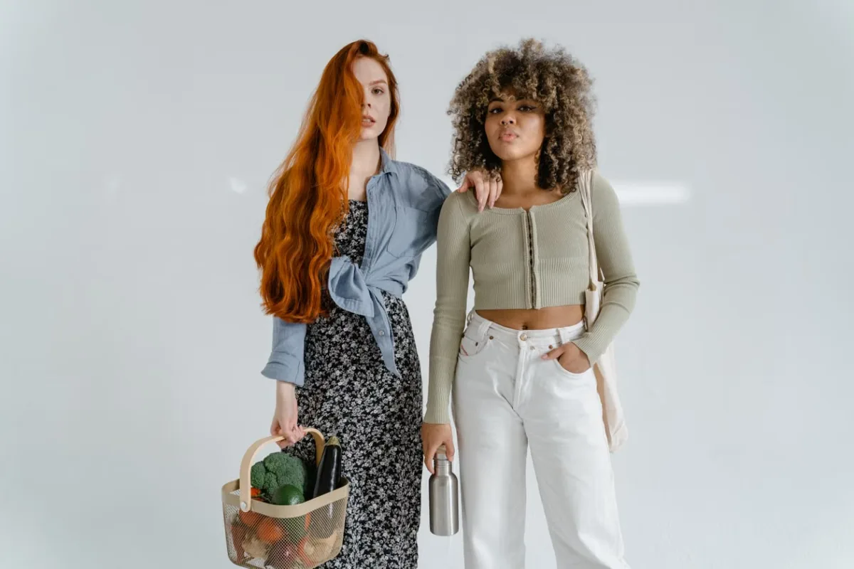Two women carrying sustainable fashion bags in an eco-friendly lifestyle setting
