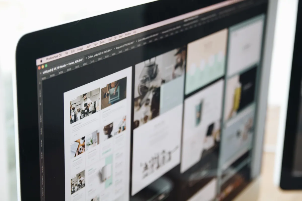 Creative professional working on Adobe Photoshop with large monitor