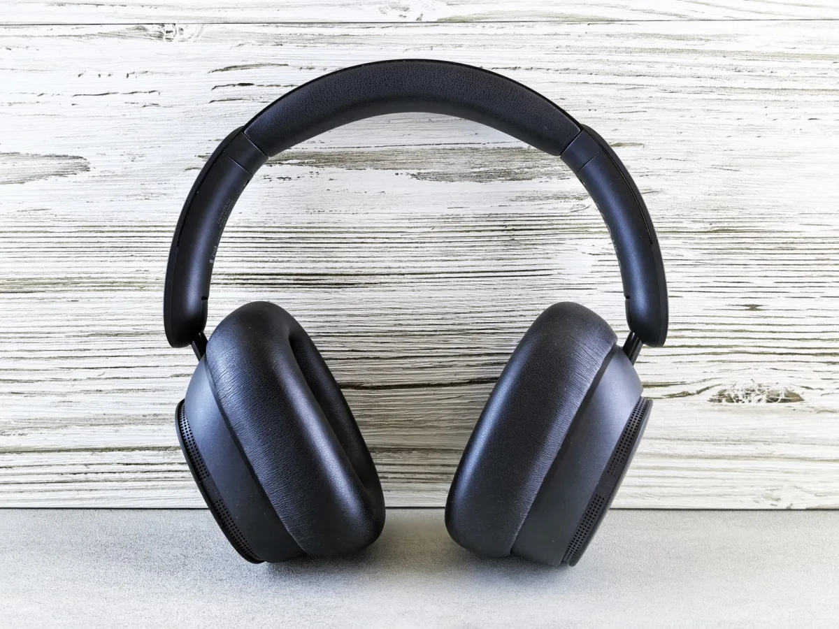 Stylish black over-ear headphones against a wooden backdrop
