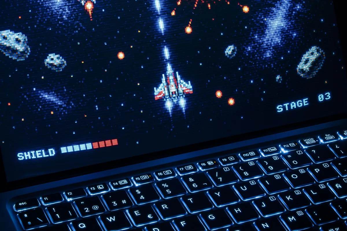 Arcade space shooter game on a laptop with illuminated keyboard — best premium gaming laptops ROG Strix Scar 16 2026