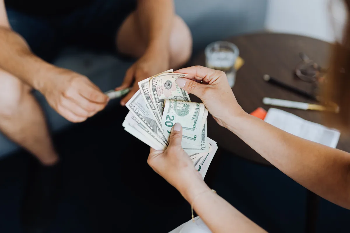 Counting US dollar bills — representing personal loan funds