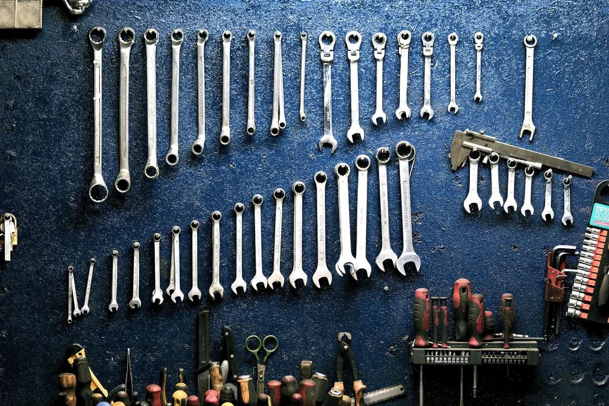 Organized workshop wall with wrenches, sockets, and mechanic tools