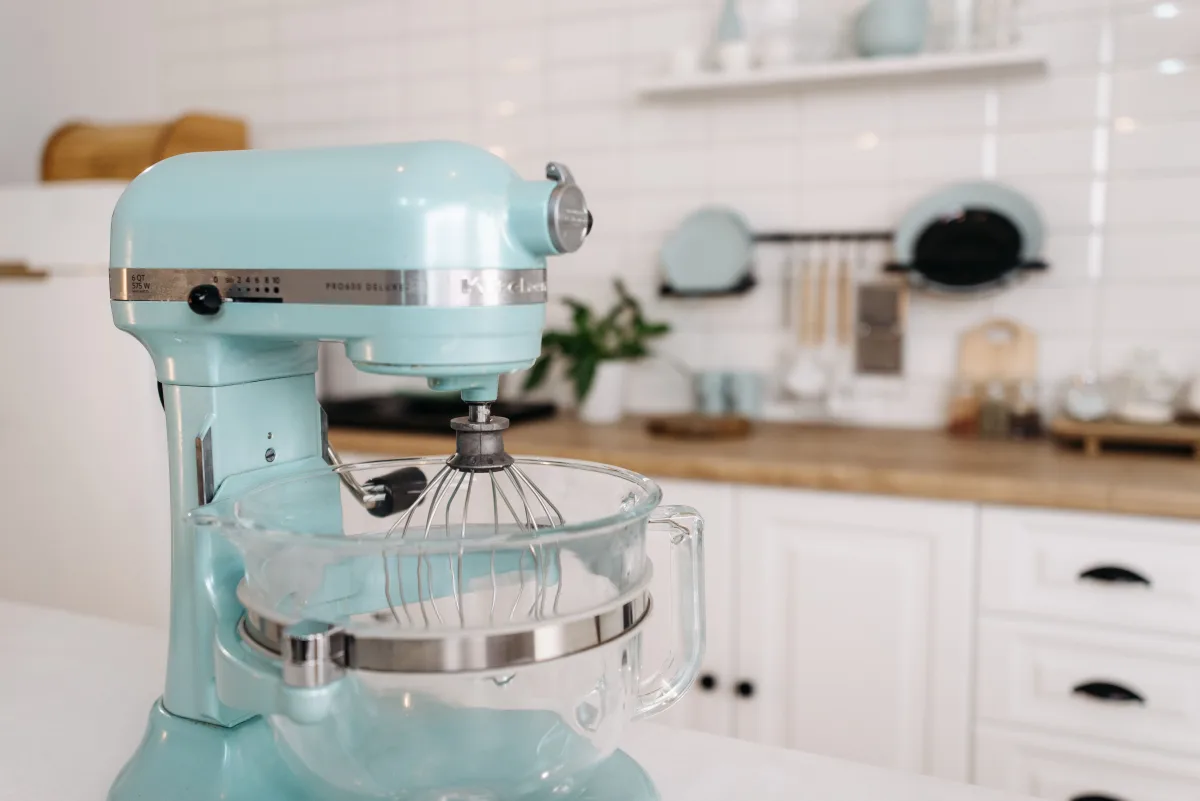 Blue stand mixer on a modern kitchen countertop