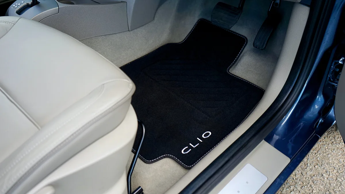 Custom branded floor mat in a Renault Clio car interior