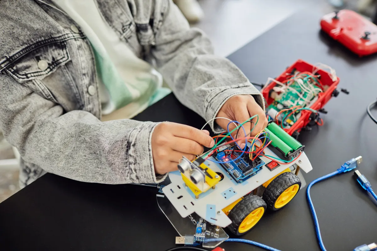 Young student assembling toy car with electronics — STEM toy marketing vs genuine educational value 2026