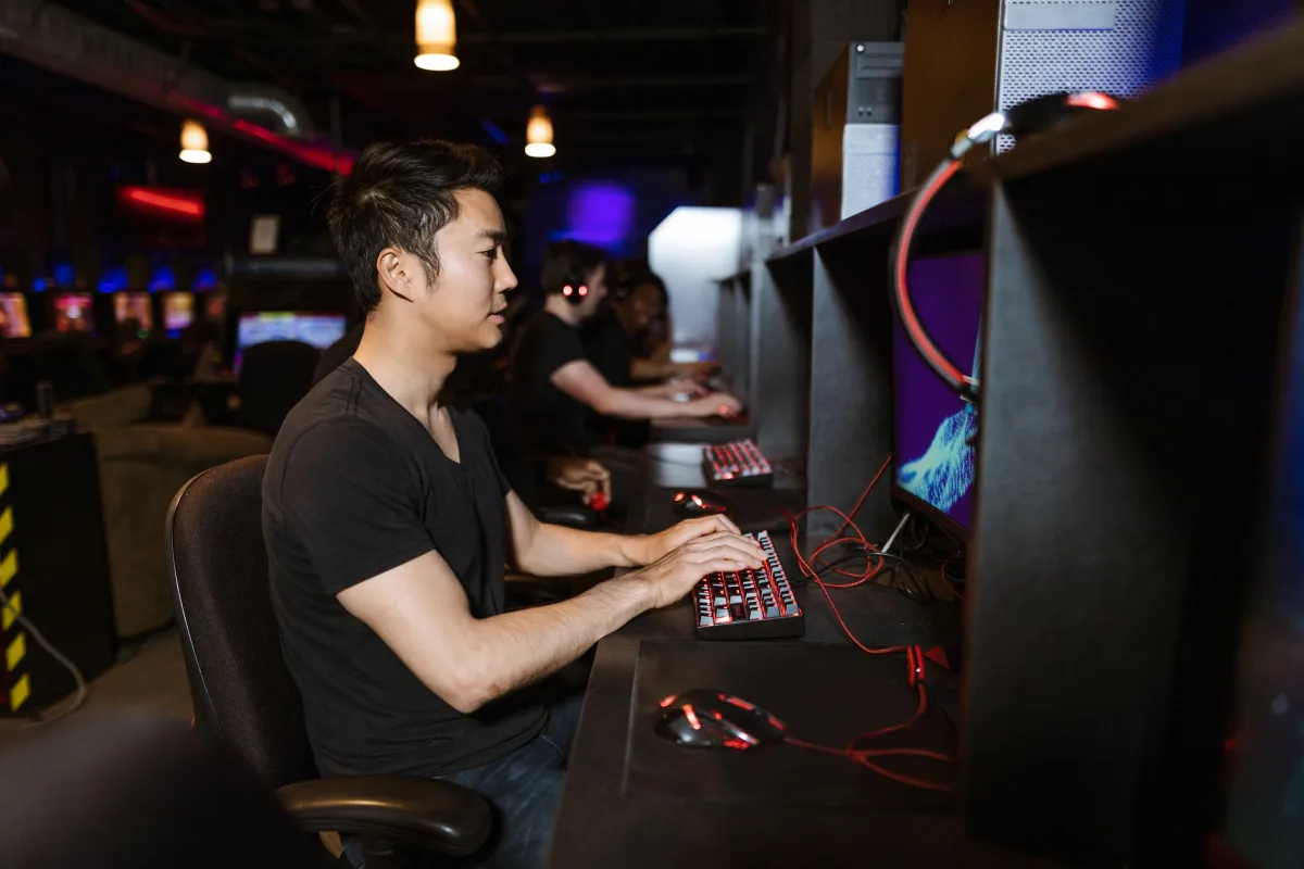 Gamer using mechanical keyboard with RGB lighting in a gaming setup