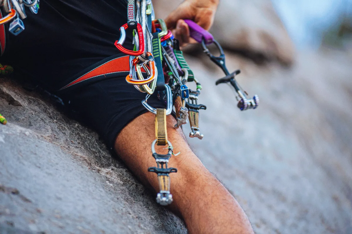 Trail running shoes and hiking boots side by side on rocky terrain