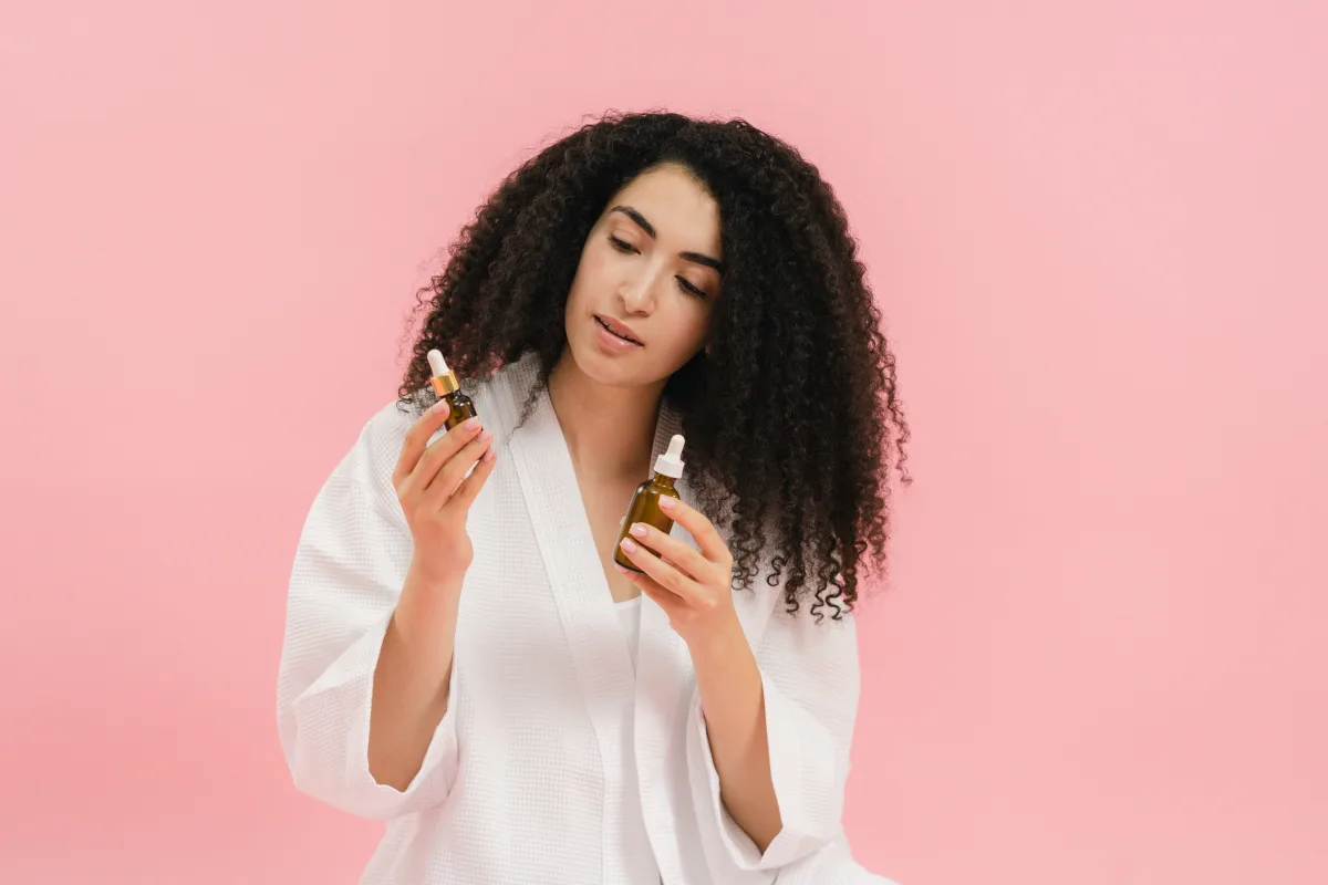 Woman comparing two skincare product bottles