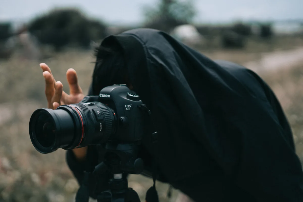 Photographer shooting wildlife outdoors with telephoto lens