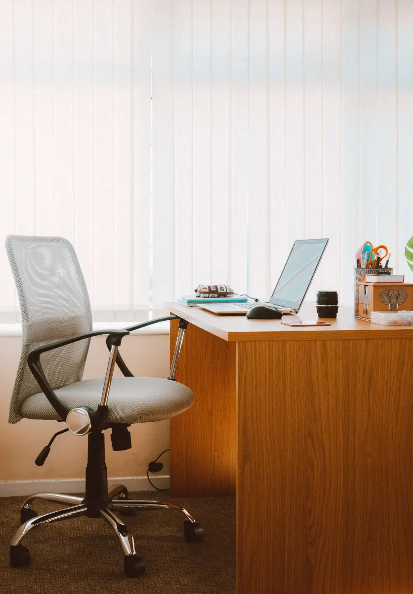 Tranquil modern home office with wooden desk, ergonomic chair, and natural light