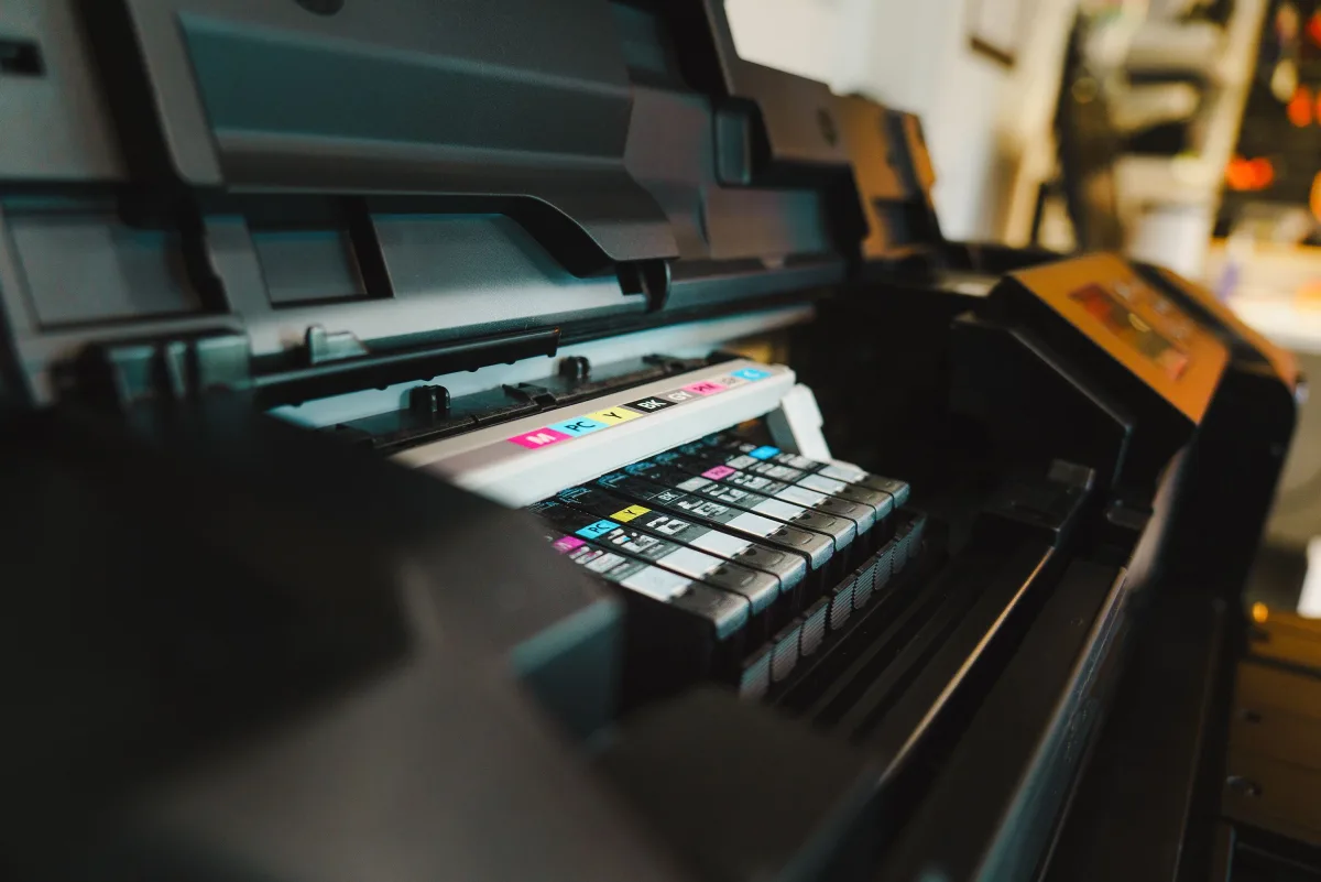 Inkjet printer with open cartridge tray in a home office setting