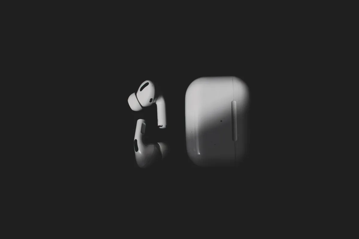 Wireless earbuds and charging case on a black background