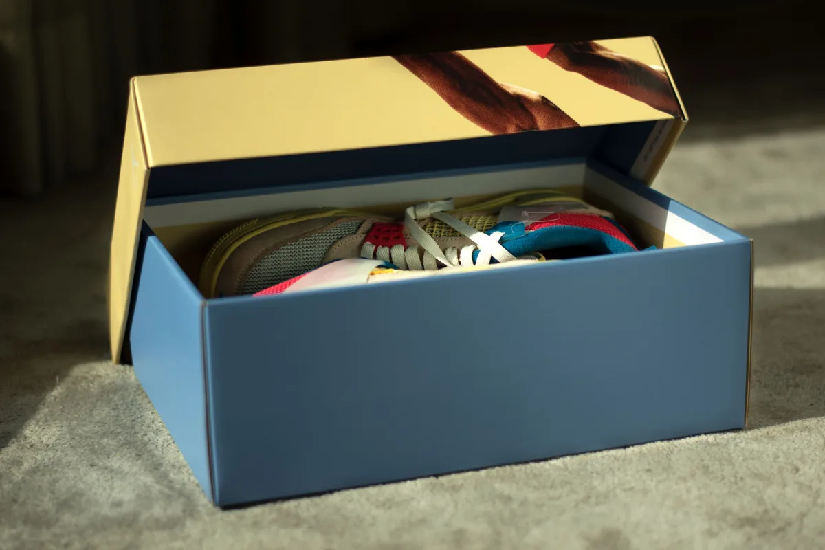 Colorful sneakers inside an open shoe box — unboxing product shot