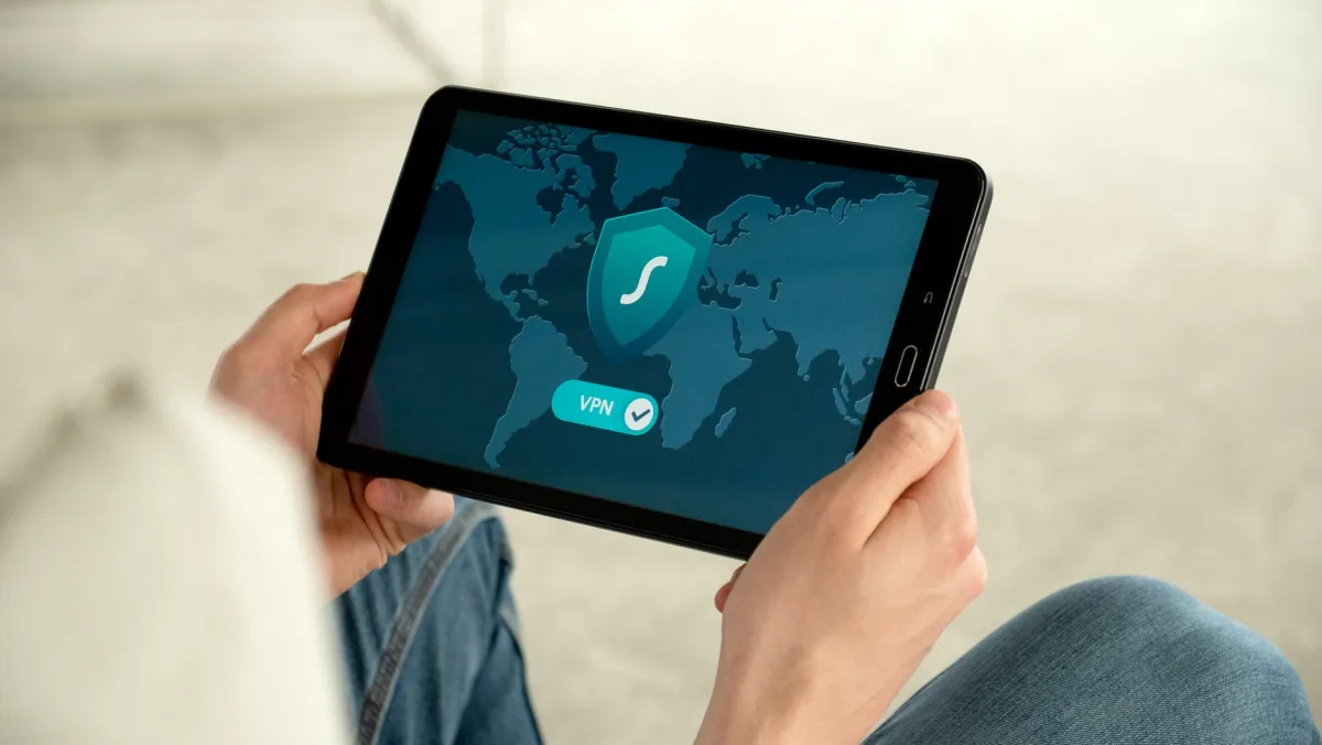Person holding a tablet with a VPN connection screen for secure internet browsing