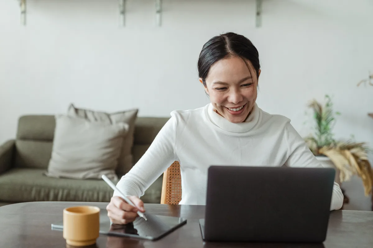 Woman making video call from home kitchen using smart display