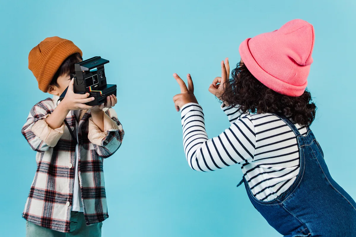 Children in trendy outfits posing in a bright studio