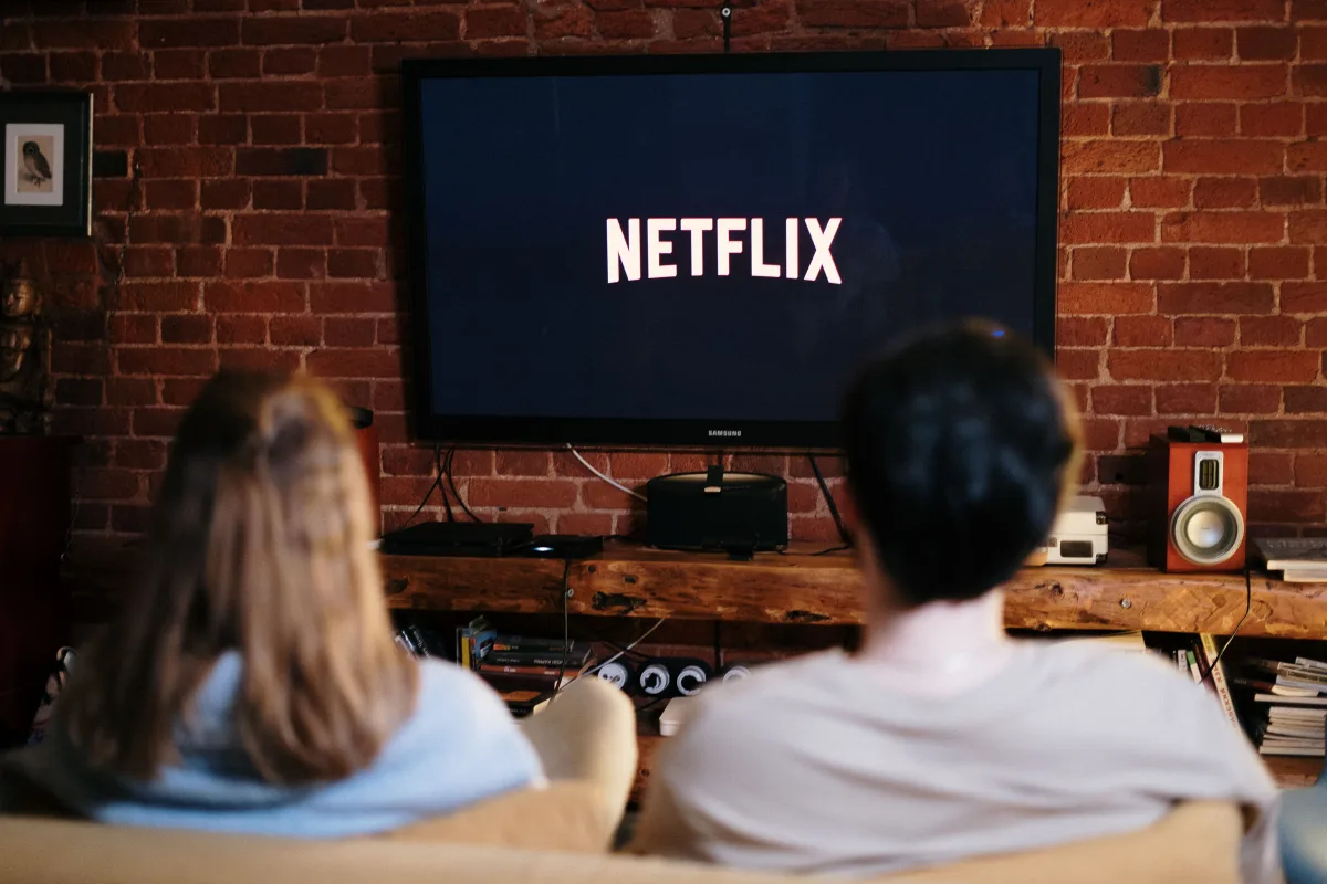 Couple watching Netflix on smart TV in living room