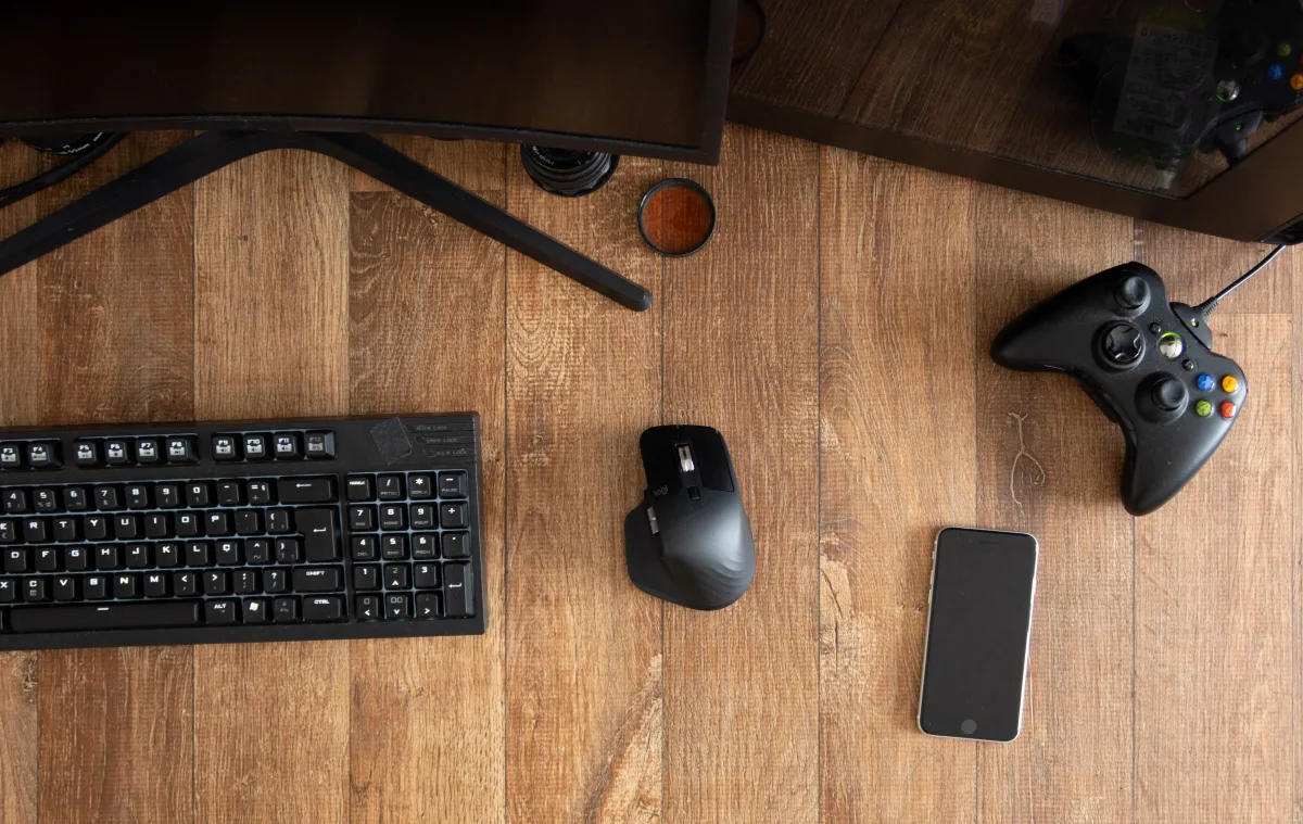 Top view of keyboard, mouse, and gaming controller on a desk
