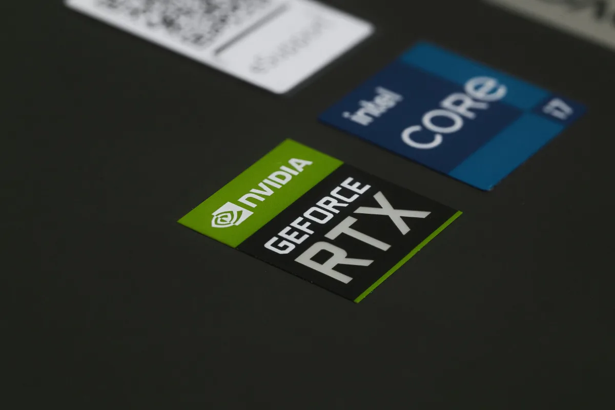 Close-up of NVIDIA GeForce RTX and Intel Core i7 stickers on a laptop — best mid-range gaming laptops 2026